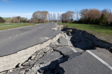 Road sunken in because of an earthquake, showing why a traveler may want earthquake insurance coverage.
