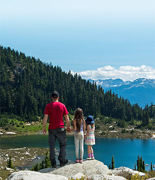 Family looking over lake in mountains