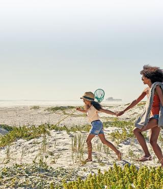 young family walking to beach