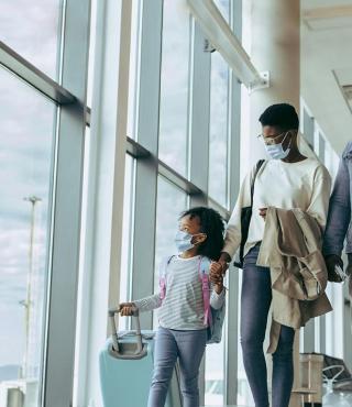 Family walking through airport passageway