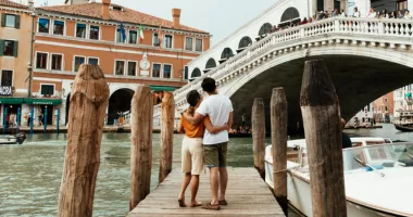 A couple enjoying a trip to Venice, one of the most romantic places in the world.