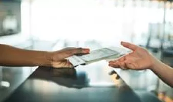 Person handing ticket to clerk