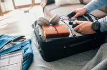 Man packing suitcase for business trip