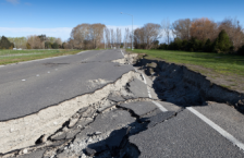 Road sunken in because of an earthquake, showing why a traveler may want earthquake insurance coverage.