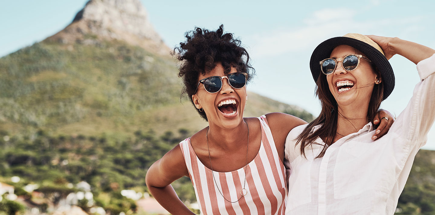 two friends laughing near mountain
