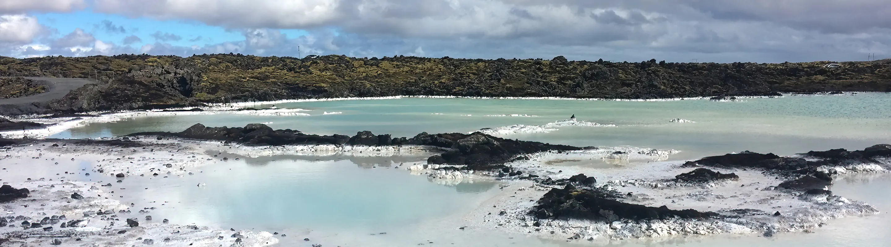 a view of a blue lagoon, highlighting the importance for visitors to get travel insurance for Iceland