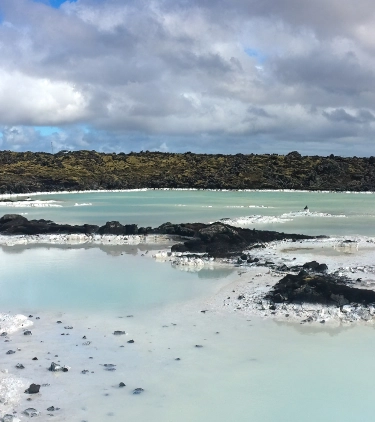 a view of a blue lagoon, highlighting the importance for visitors to get travel insurance for Iceland