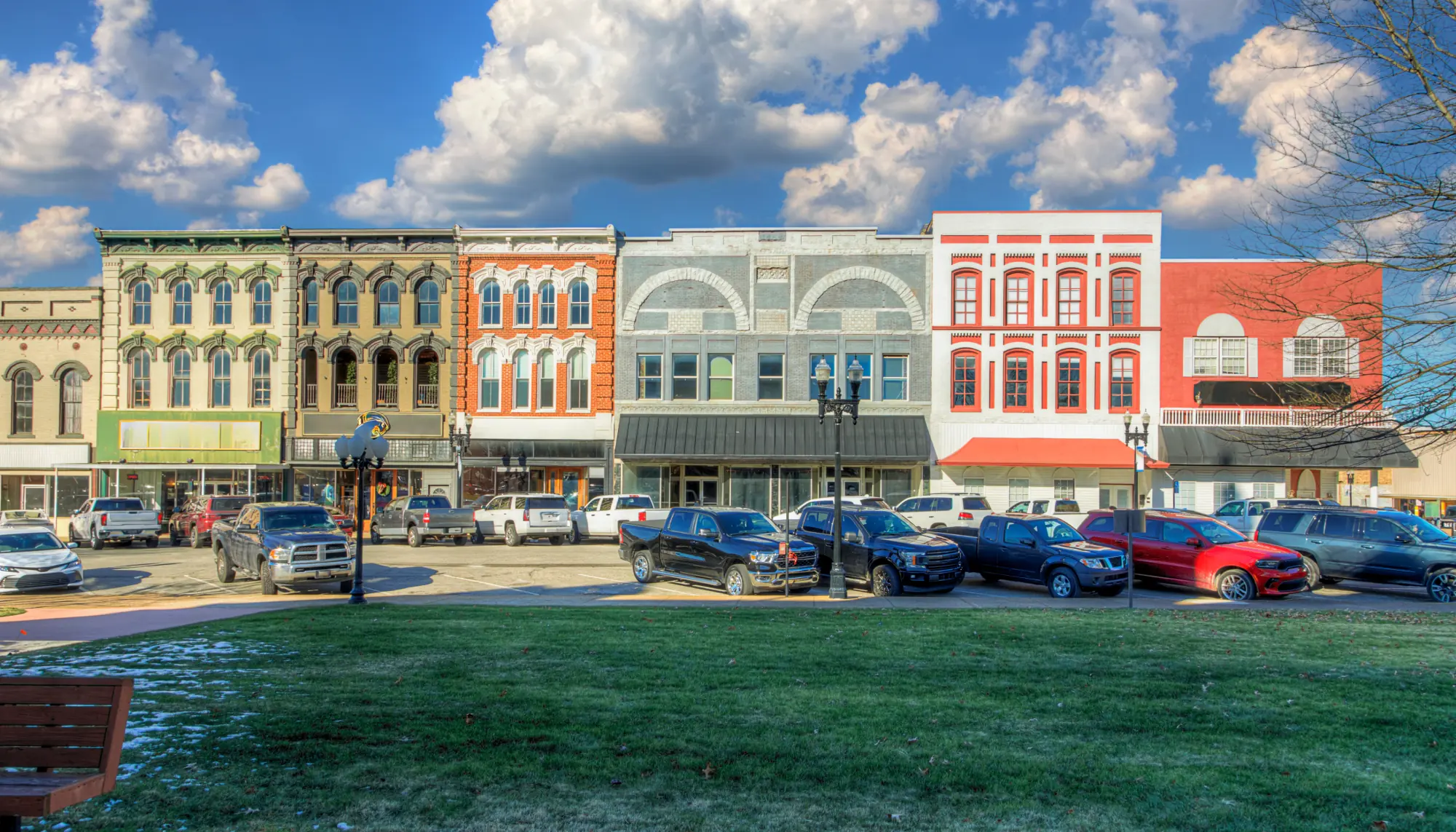 View of colorful buildings and parked cars in the U.S. city of Paris, highlighting travel insurance for Tennessee