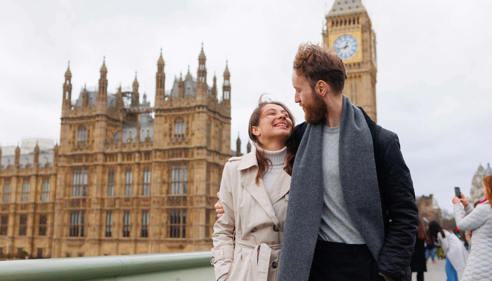 a couple hugging and strolling through the streets of London after reading Travelex's United Kingdom travel guide 