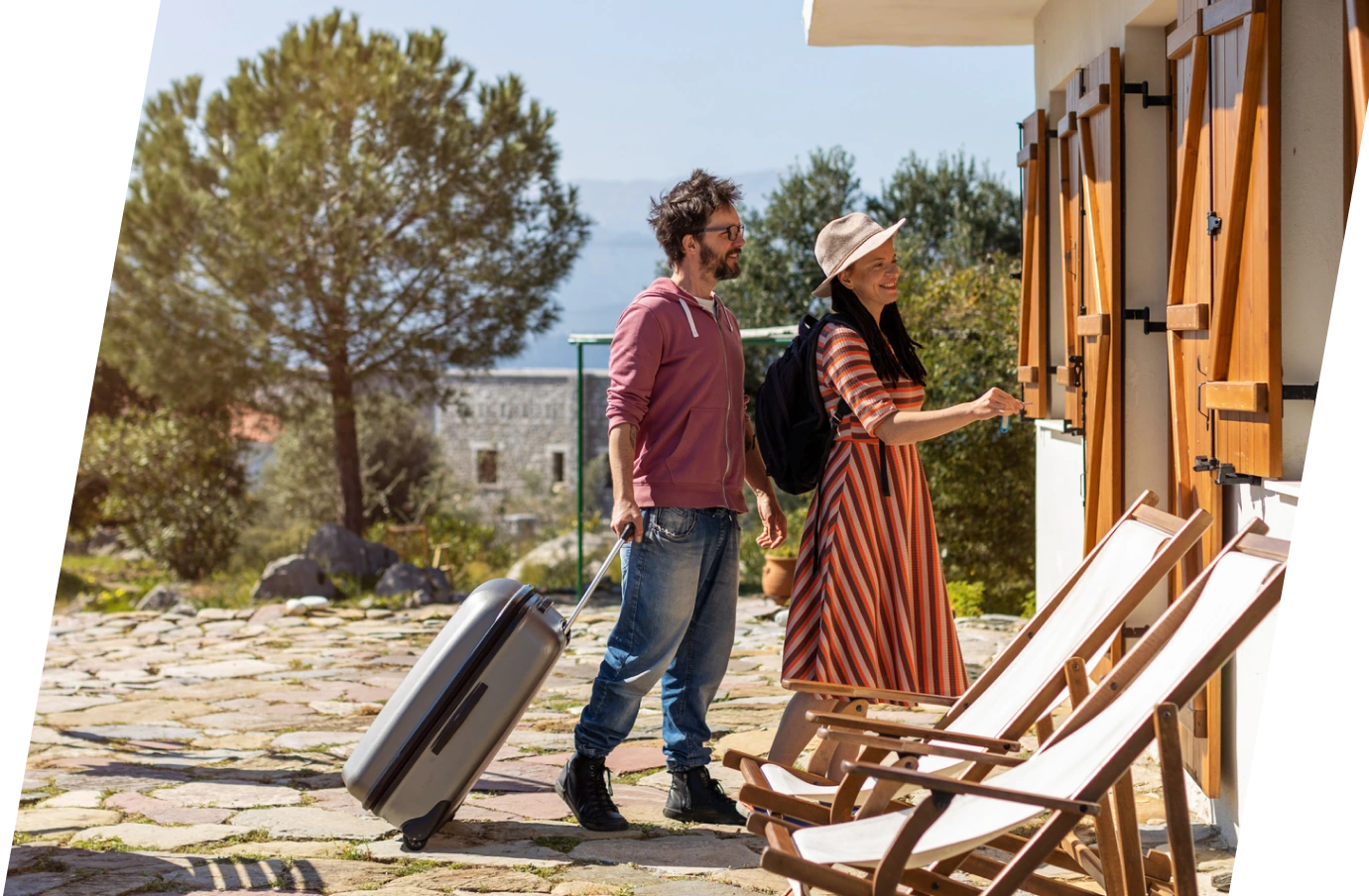 couple with travel insurance for Greece, checking in to their vacation rental on a Greek Island