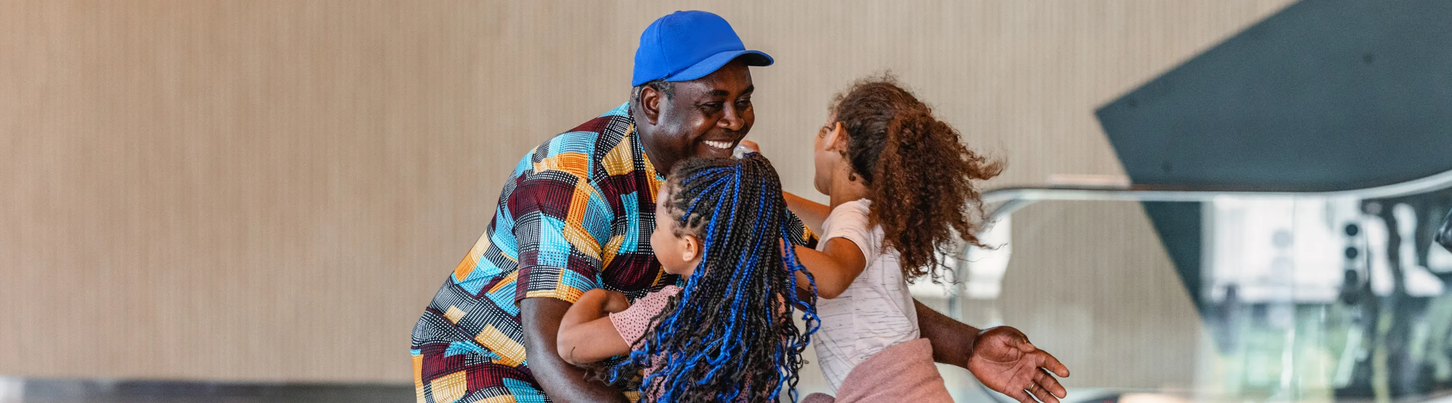 a father with travel insurance for city trips reunites with his two young daughters at the airport after his vacation