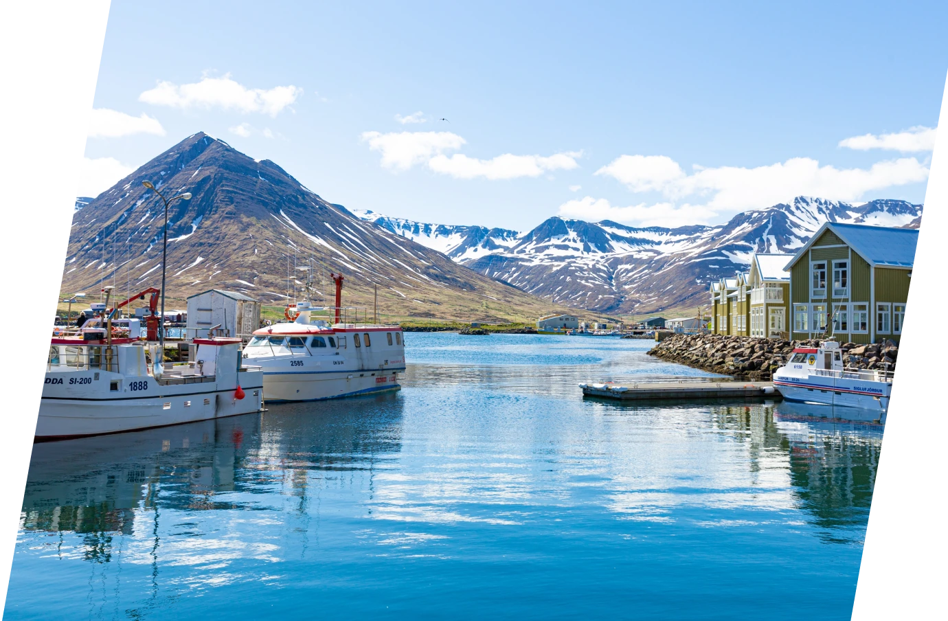a harbor scene in Siglufjorour, where travelers visit with travel insurance for Iceland