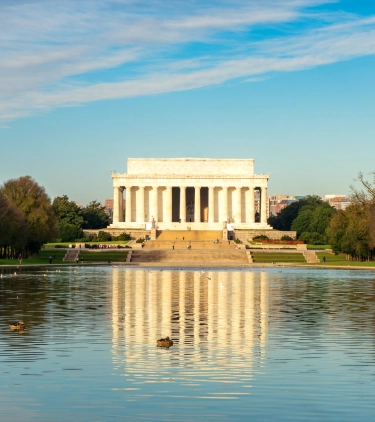 a view of the Lincoln Memorial in summertime, where people visit with travel insurance for Washington D.C. 