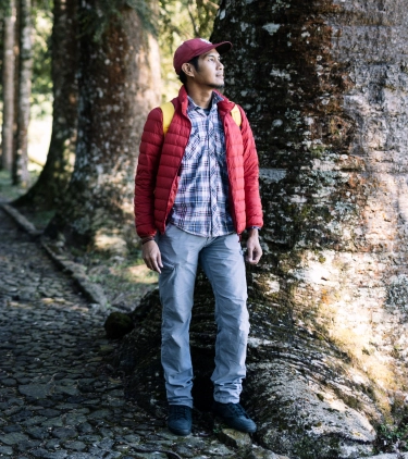 Man walking in a forest with travel insurance for Bali