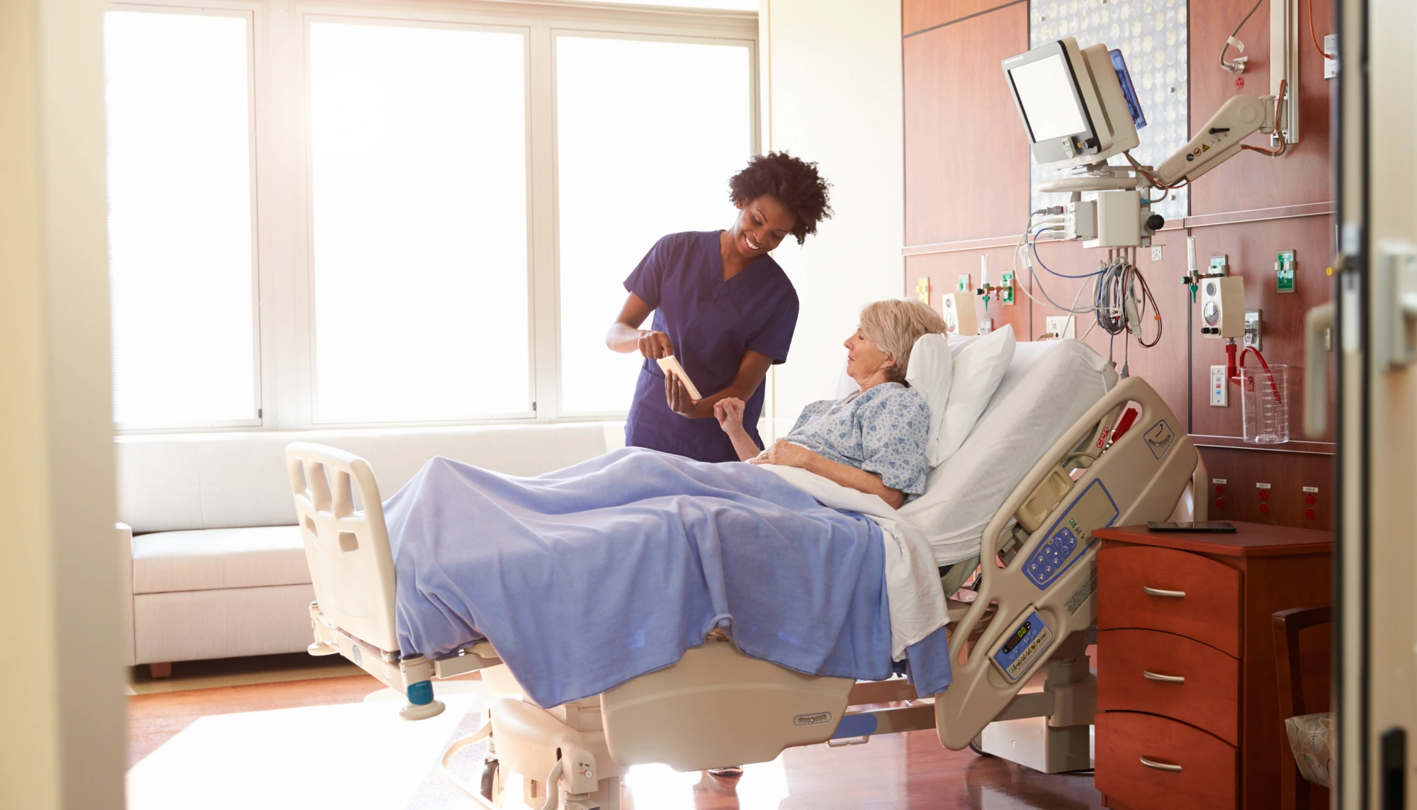 an elderly patient is being attended to by a nurse after needing to go to the hospital on vacation
