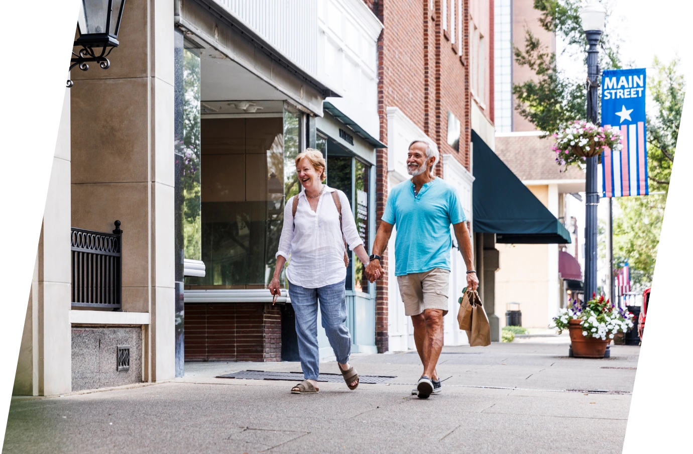 Senior couple with travel insurance for Tennessee walking through town and looking at shops