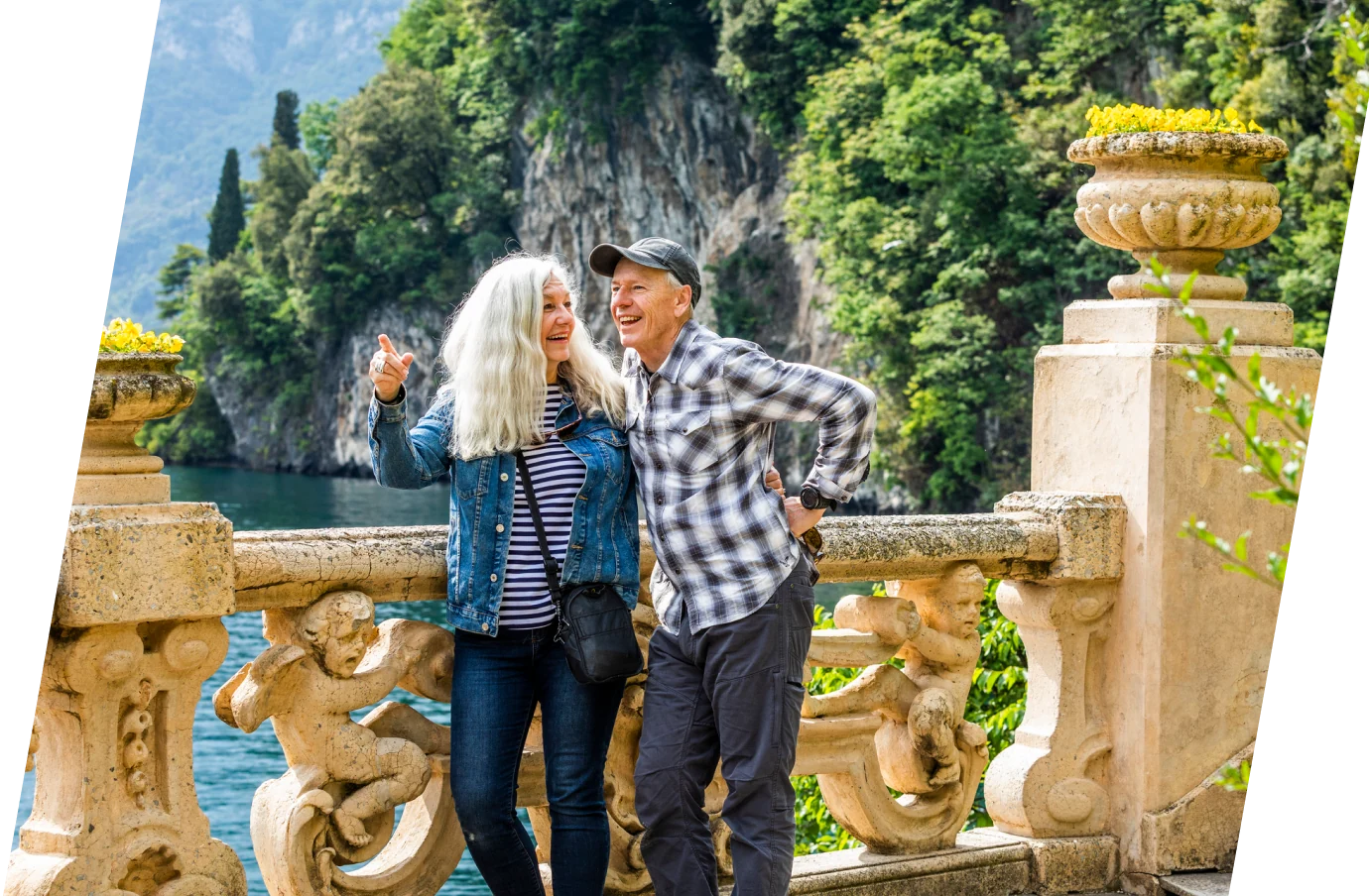 Senior couple with last-minute travel insurance in Lake Cuomo looking at scenery