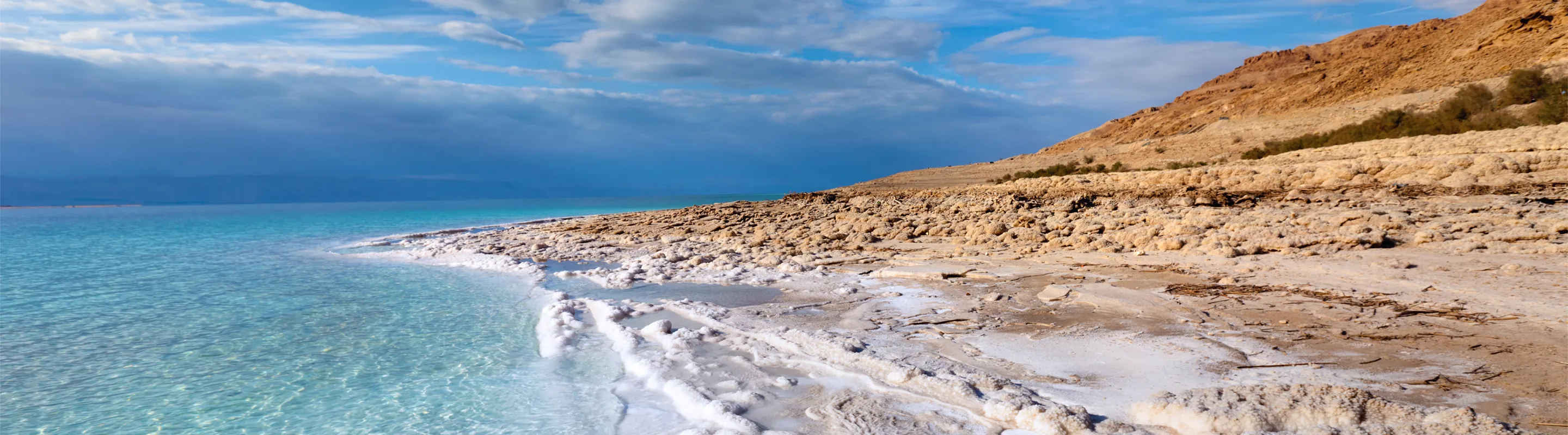 a view of the Dead Sea's shoreline on the Jordanian side, where many people visit with travel insurance for Jordan