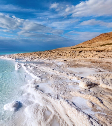 a view of the Dead Sea's shoreline on the Jordanian side, where many people visit with travel insurance for Jordan