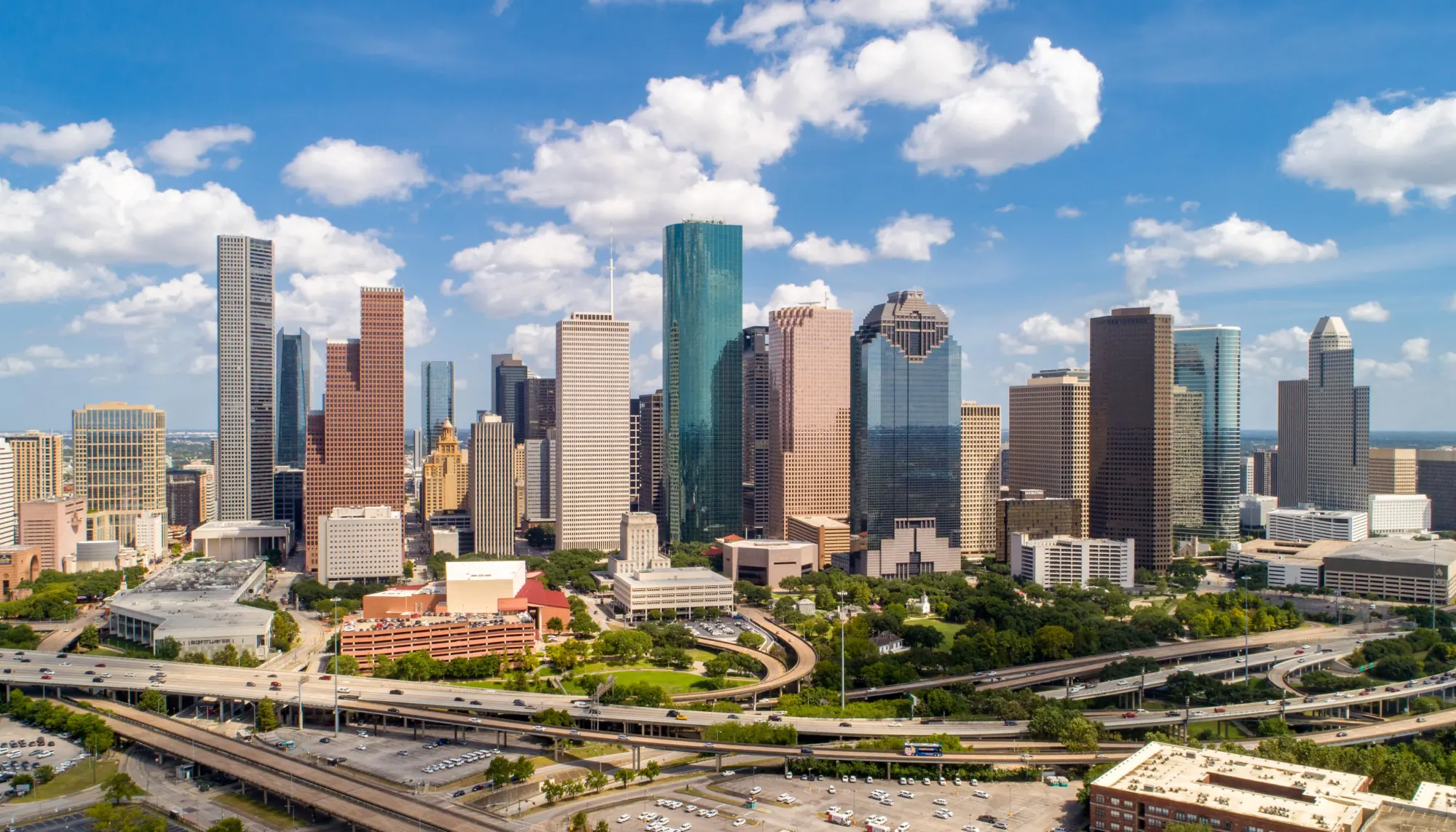 an aerial view of the skyline in Houston, Texas, on a sunny day, a place where travel insurance for hurricanes is relevant