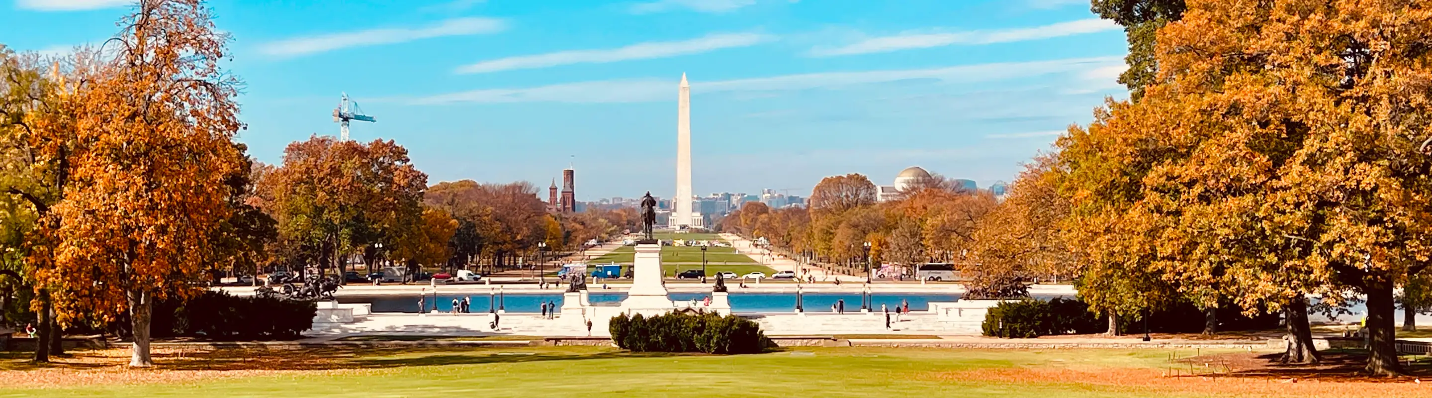 a view of the Washington Monument in autumn, a place where people visit with travel insurance for Washington D.C. 