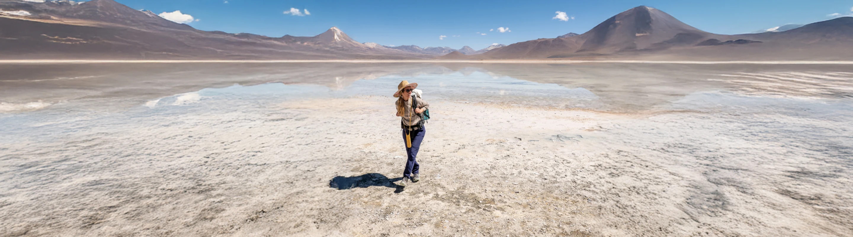 Woman with travel insurance for South America hiking in the desert in Bolivia with a backpack on
