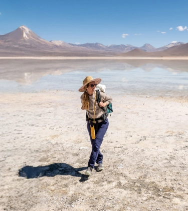 Woman with travel insurance for South America hiking in the desert in Bolivia with a backpack on