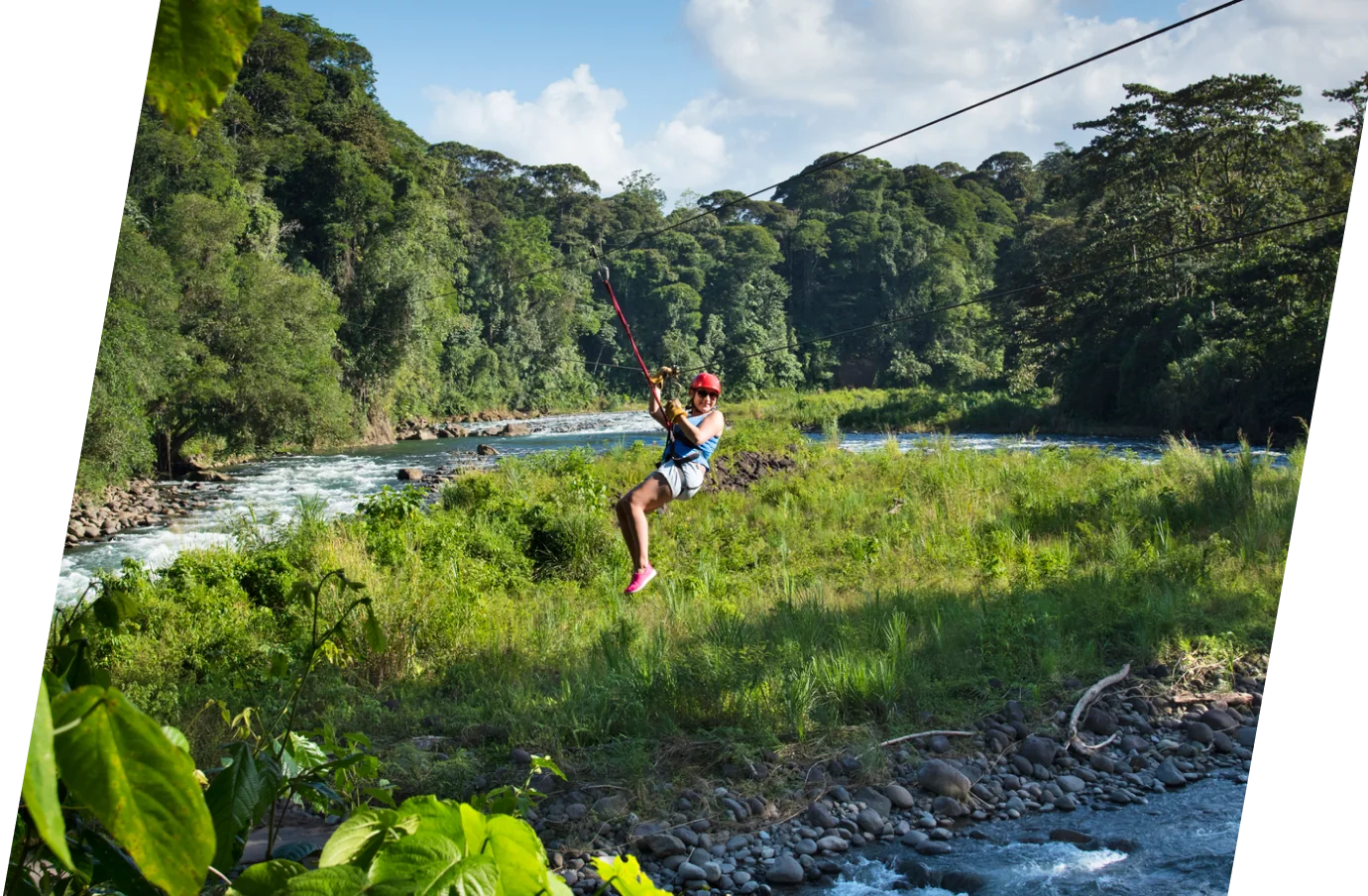 woman with travel insurance for Costa Rica, ziplining through a rainforest