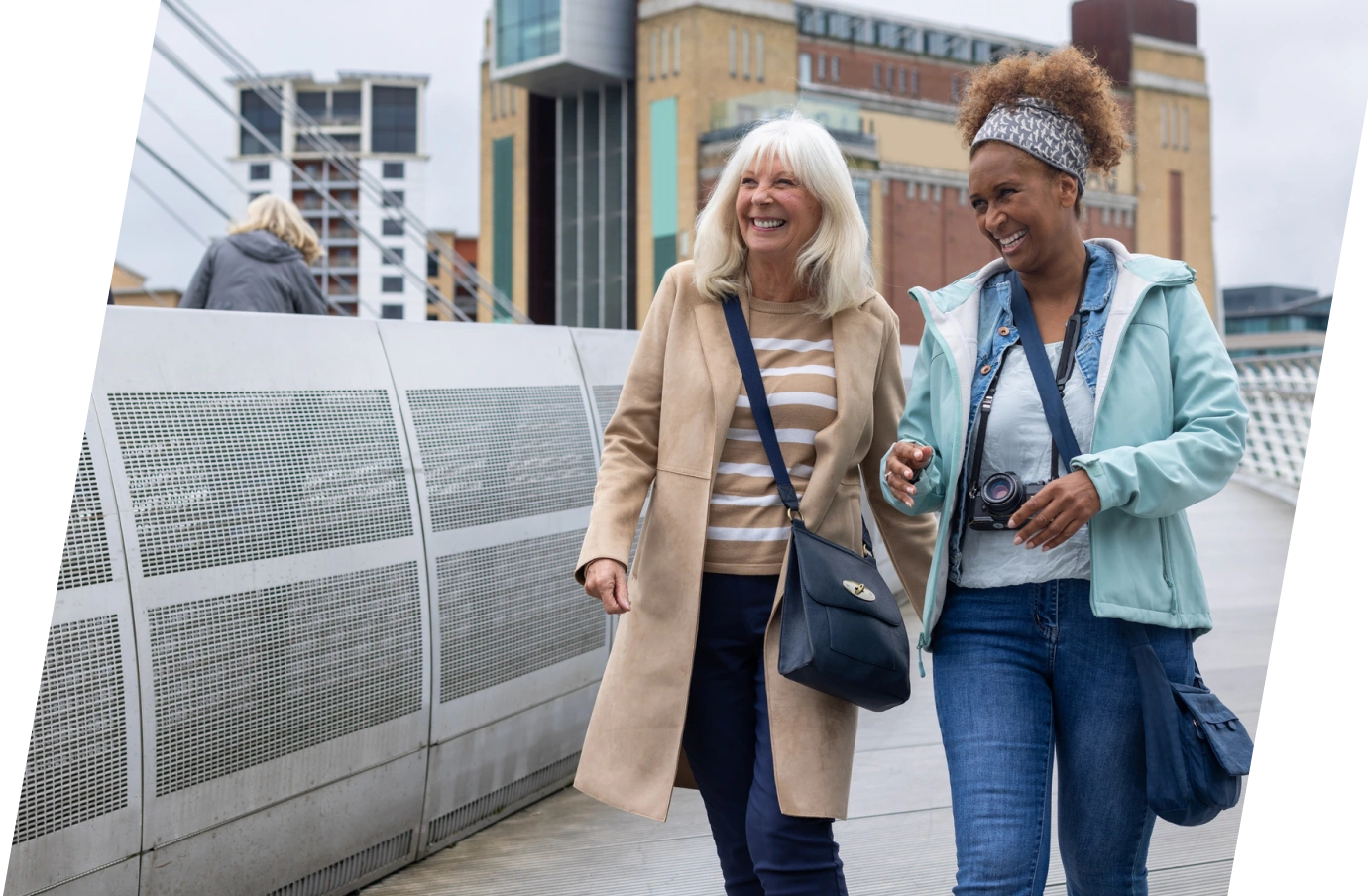 Two middle-aged women walking through London with travel insurance for the United Kingdom