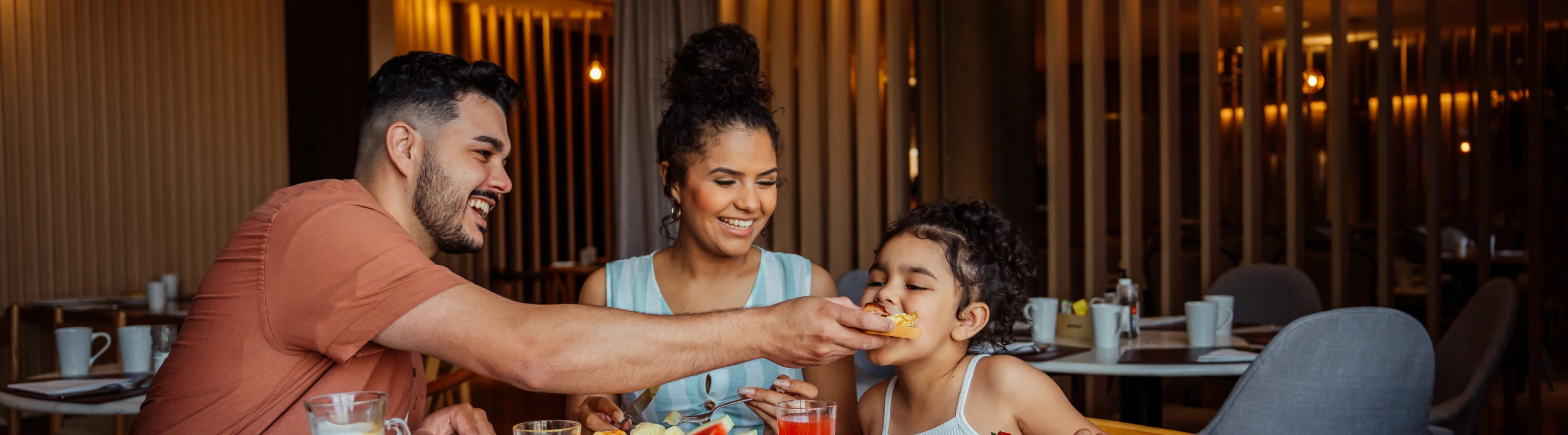 a family with travel insurance for culinary vacations shares a meal in a cozy restaurant 