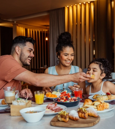a family with travel insurance for culinary vacations shares a meal in a cozy restaurant 