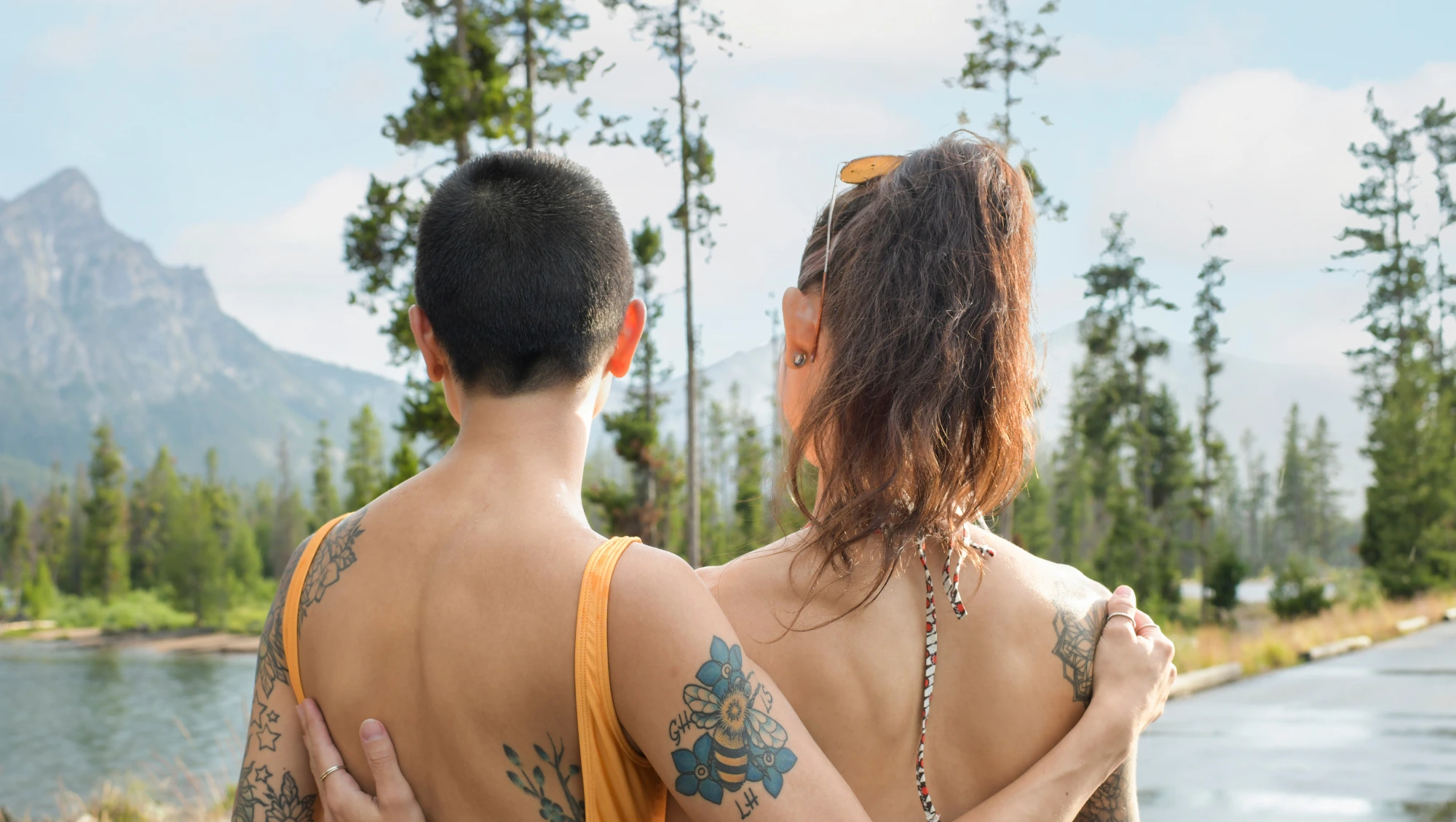 a couple embraces while soaking up lake and mountain views, a viewpoint they read about in a United States travel guide 