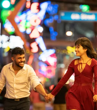 a young couple holds hands and explores the city's nightlife, insured with travel insurance for Las Vegas