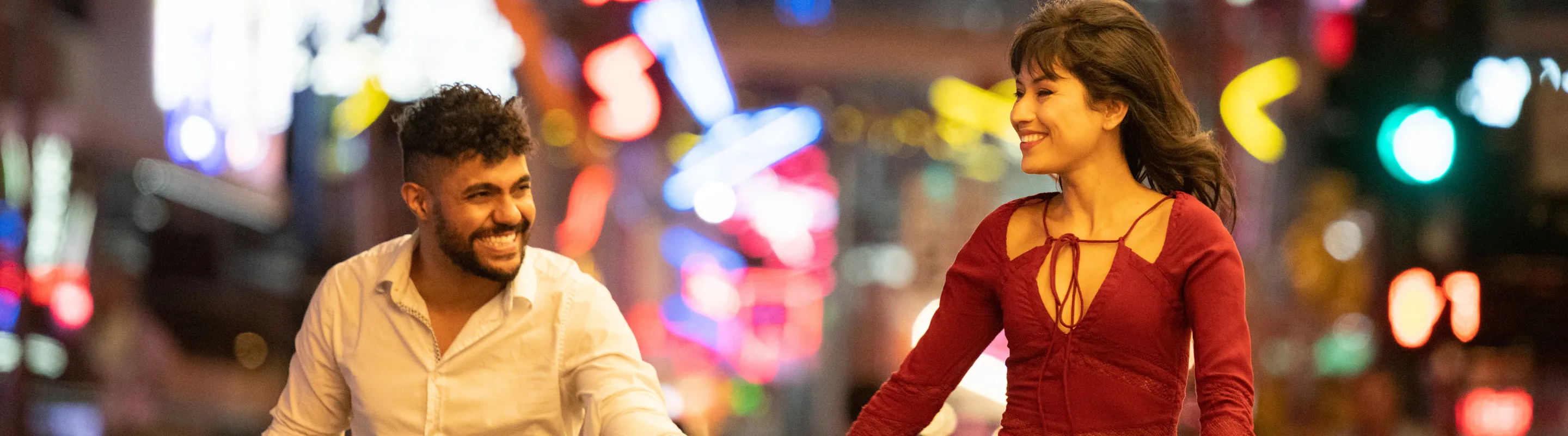 a young couple holds hands and explores the city's nightlife, insured with travel insurance for Las Vegas