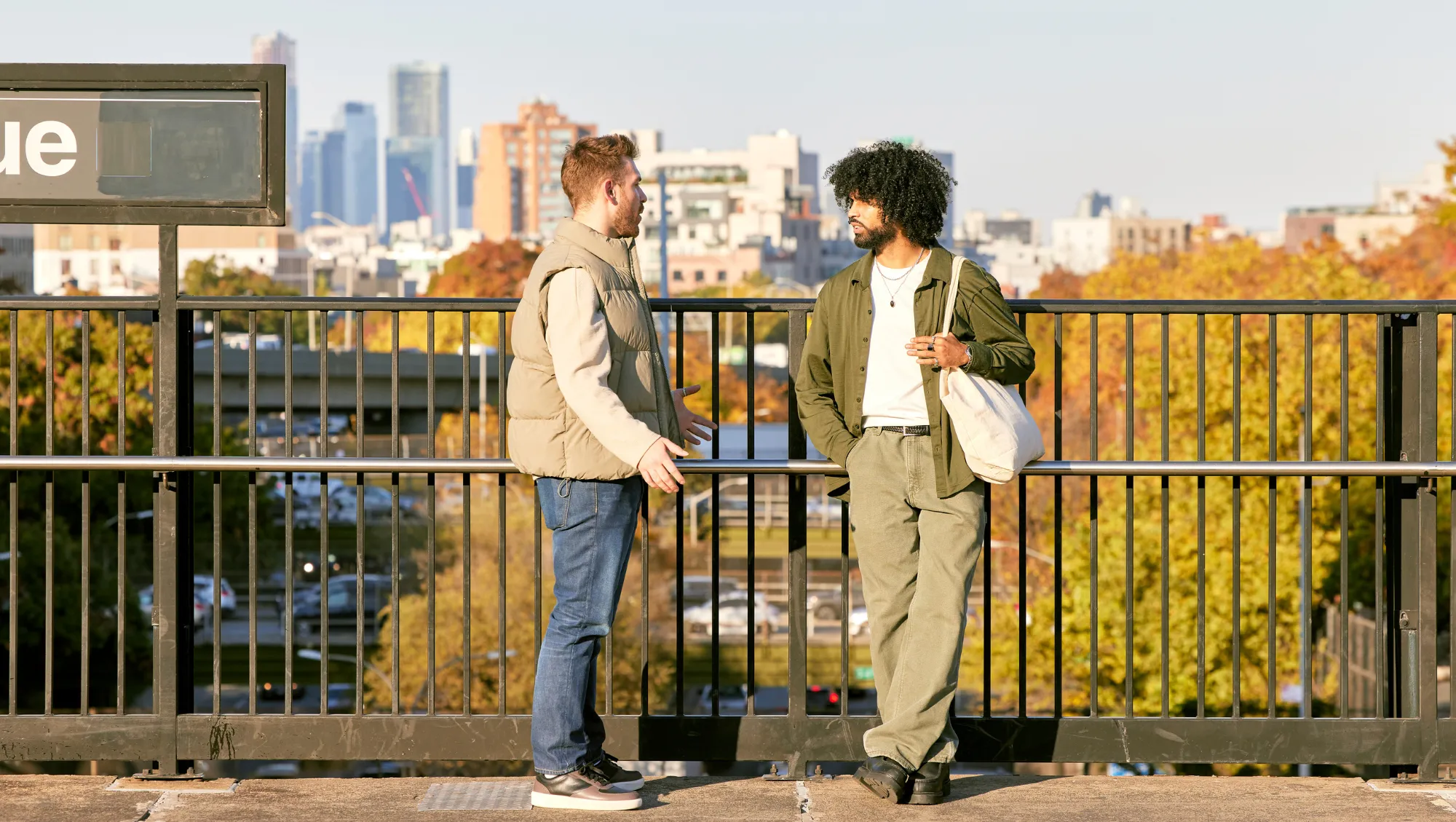 two friends talk on a subway platform on vacation after researching, "Does travel insurance cover terrorism?"