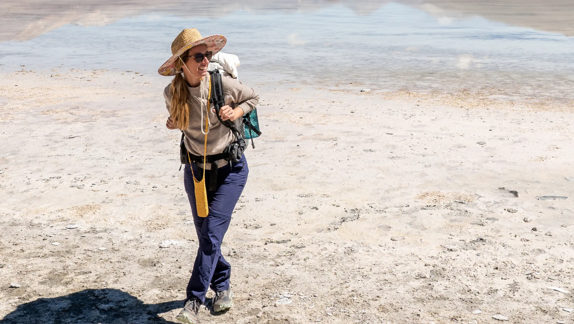 a woman hikes in the desert in Bolivia on vacation after researching responsible traveler best practices 