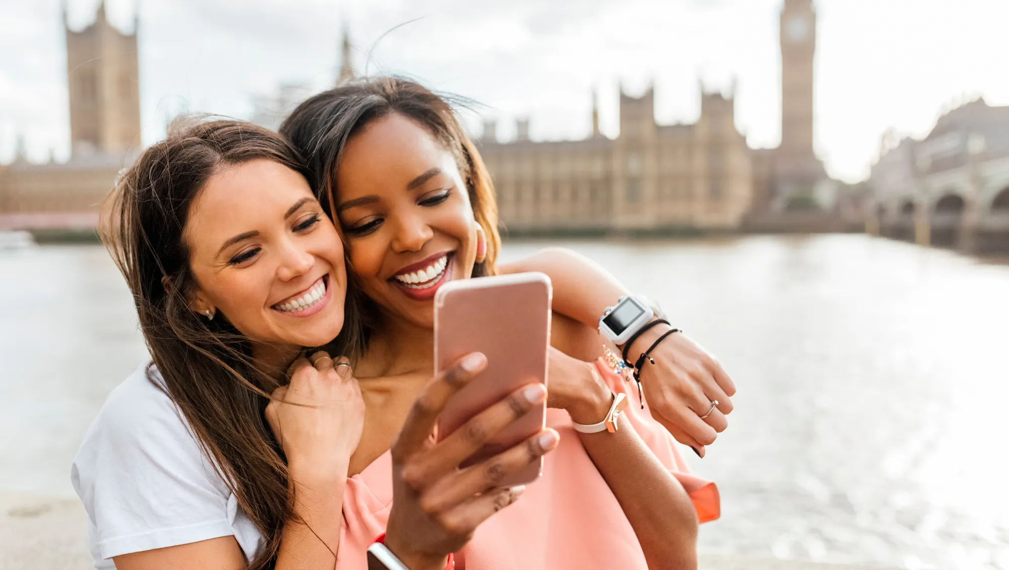 two women look at our travel app on a phone during their travels in London