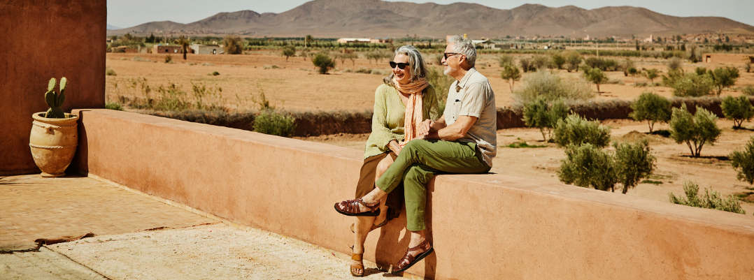 senior couple sitting on a rooftop in Morocco, one of the most romantic places in the world
