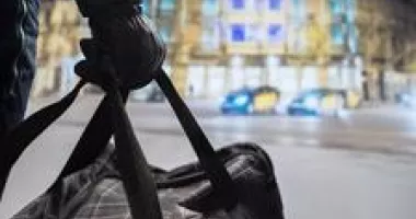 Gloved hand holding a duffel bag