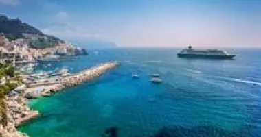 Cruise ship pulling up to a beautiful island