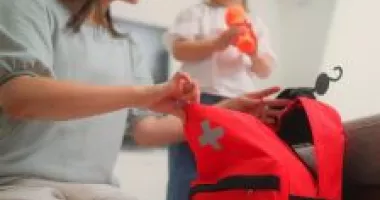 Woman and girl packing an emergency bag.