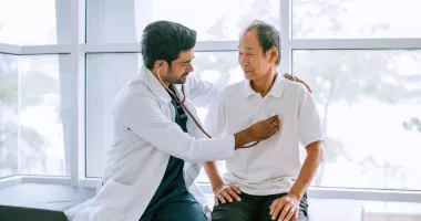 Doctor checking patient&#039;s heart at a travel health care appointment