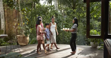 Family getting welcome drinks at a resort after deciding all-inclusives are worth it