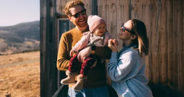 Couple with baby on vacation after researching the best places to travel with a baby