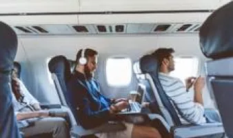Travelers working and relaxing on a flight