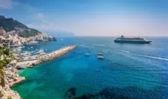 Cruise ship pulling up to a beautiful island