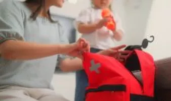Woman and girl packing an emergency bag.