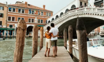 A couple enjoying a trip to Venice, one of the most romantic places in the world.