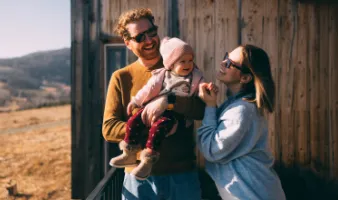 Couple with baby on vacation after researching the best places to travel with a baby