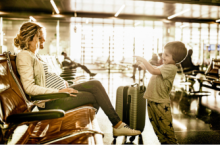 Mother at the airport for travel during pregnancy with her young son.